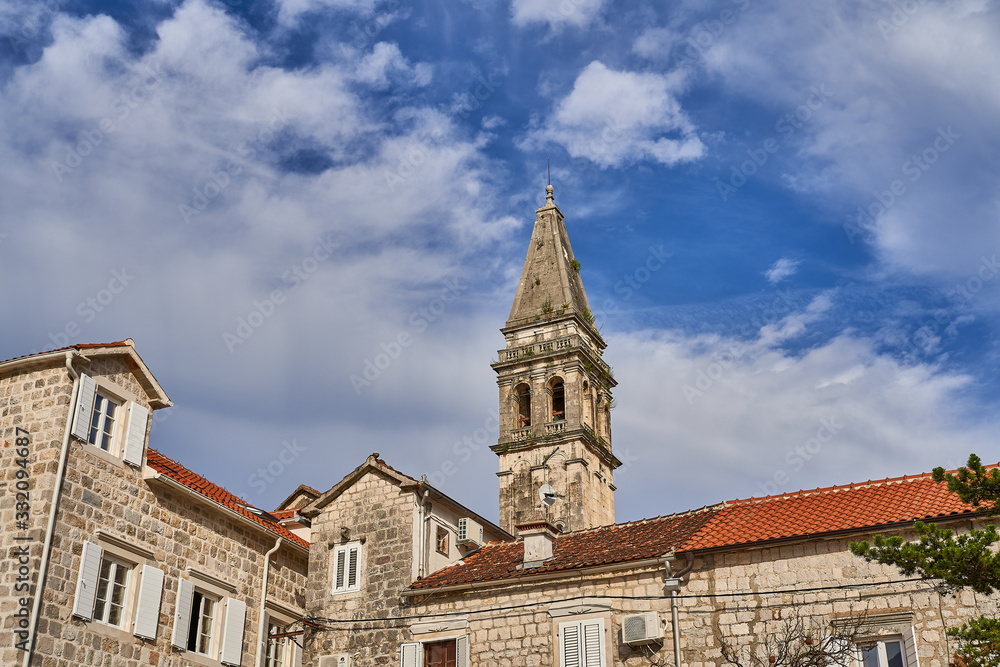 Fototapeta premium bell tower of the church against the sky in the city of Perast
