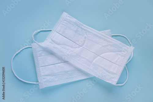 white medical masks on a blue background, a means of protection against the virus, doctor's accessory
