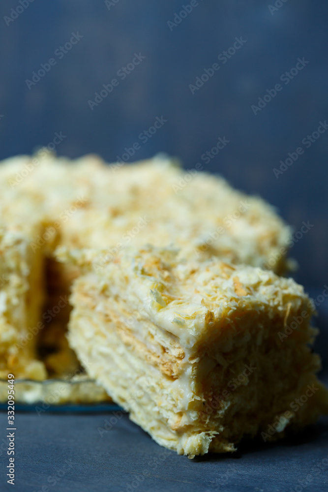 homemade Napoleon cake with cream on a gray background homemade Napoleon cake with cream on a gray background