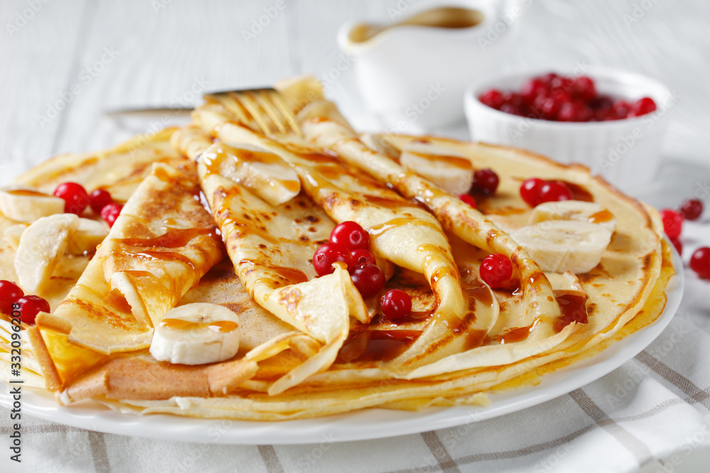 crepes served with berries and caramel sauce crepes served with berries and caramel sauce