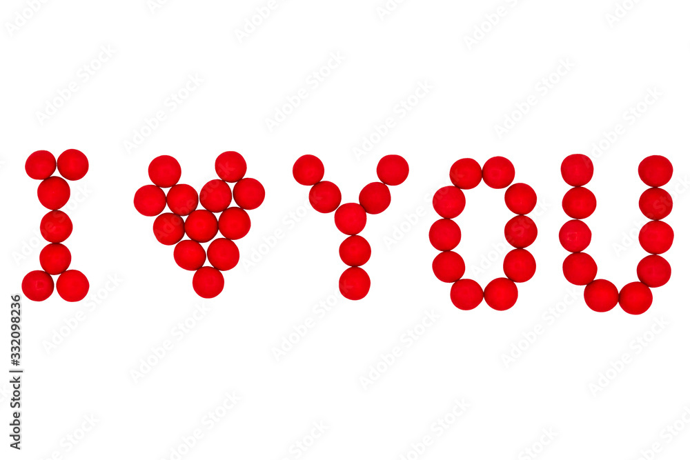 Fototapeta premium Letters and a heart made of red candies on a white background are laid out