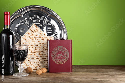 Symbolic Pesach (Passover Seder) items on wooden table, space for text