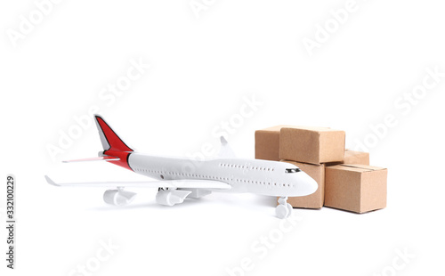 Airplane model and carton boxes on white background. Courier service
