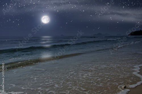 Beautiful lonely beach with full moon in the night photo