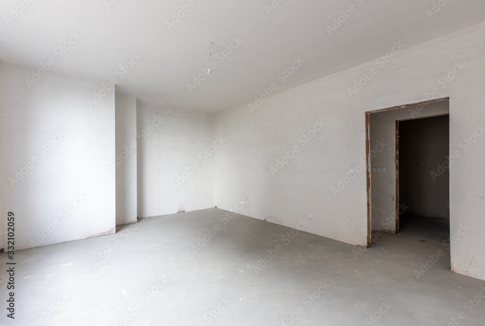 New empty room under construction. Plaster walls. New home. Concrete walls. Interior renovation. New empty room under construction. Plaster walls. New home. Concrete walls. Interior renovation.