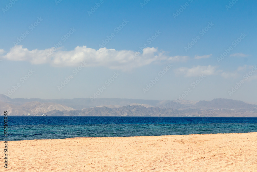 Sandy beach - Japanese Gardens in Jordan. White sand. Mountains can be seen in the distance.