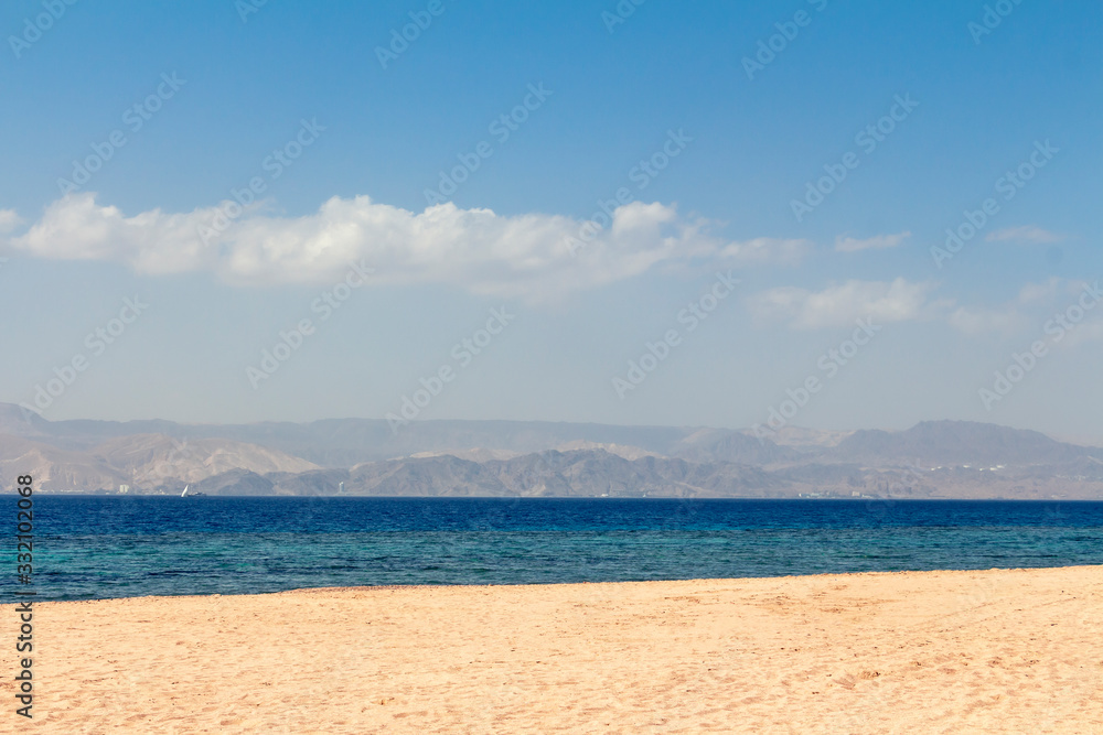 Sandy beach - Japanese Gardens in Jordan. White sand. Mountains can be seen in the distance. Sandy beach - Japanese Gardens in Jordan. White sand. Mountains can be seen in the distance.