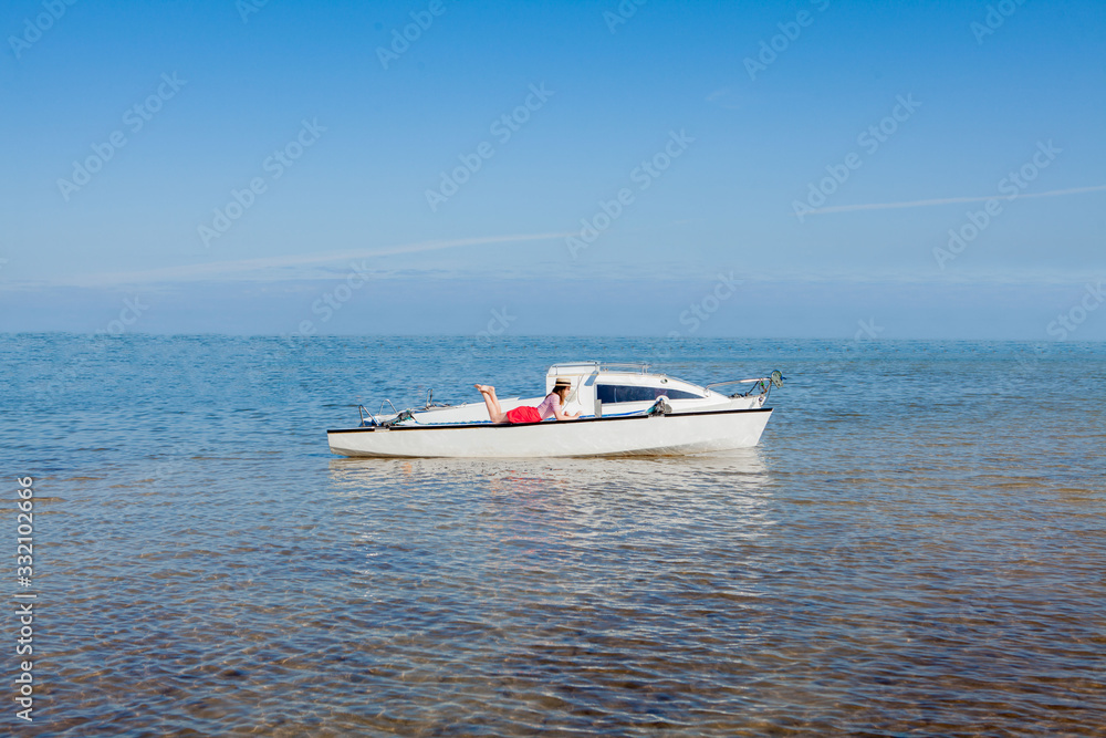 Young and handsome woman with laptop computer on sailboat. Freelance work concept Young and handsome woman with laptop computer on sailboat. Freelance work concept