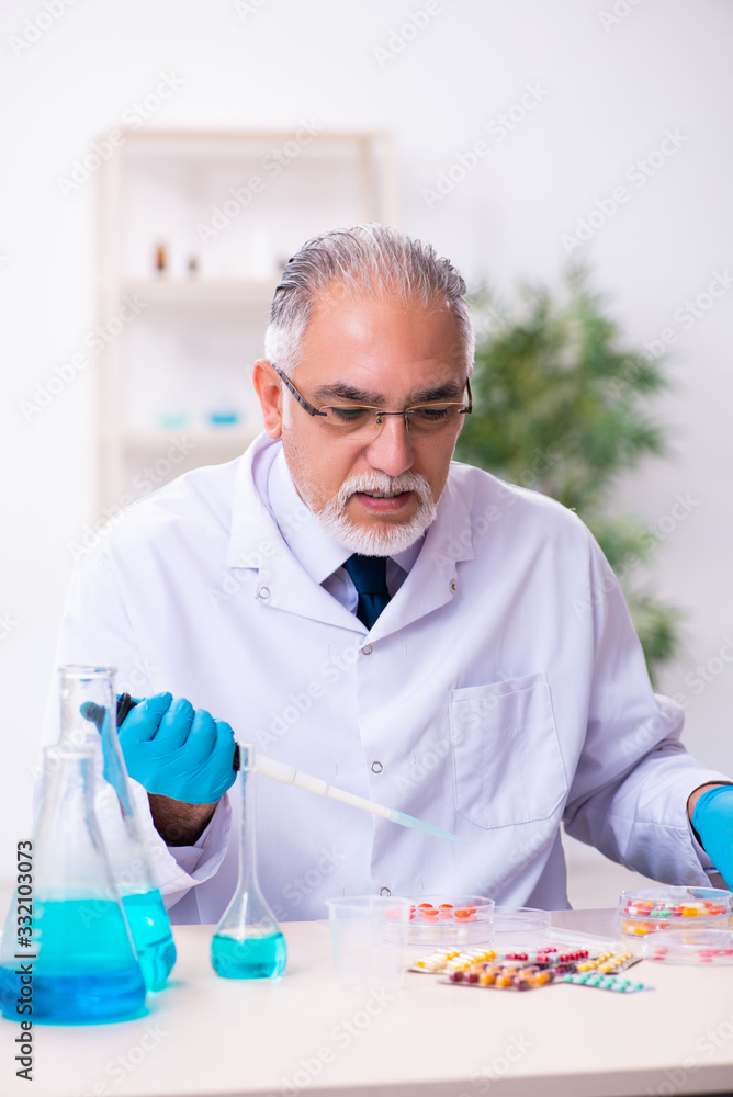 Old male chemist working in the lab Old male chemist working in the lab