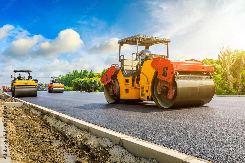 Construction site is laying new asphalt road pavement,road construction workers and road construction machinery scene.highway construction site landscape. Construction site is laying new asphalt road pavement,road construction workers and road construction machinery scene.highway construction site landscape.