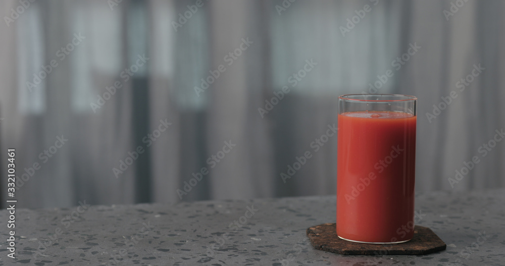 tomato juice in glass on concrete surface with copy space tomato juice in glass on concrete surface with copy space