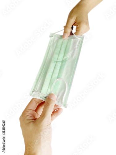 A male hand is giving a mask to a woman Protect Covid 19 On a white background