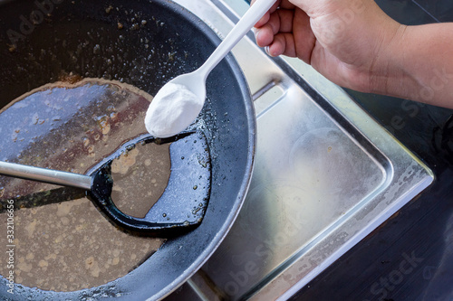 Baking soda to soak and remove burnt-on food in the bottom of pots and pans photo