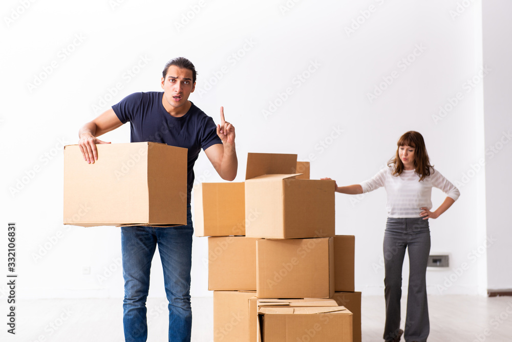 Young pair and many boxes in divorce settlement concept Young pair and many boxes in divorce settlement concept