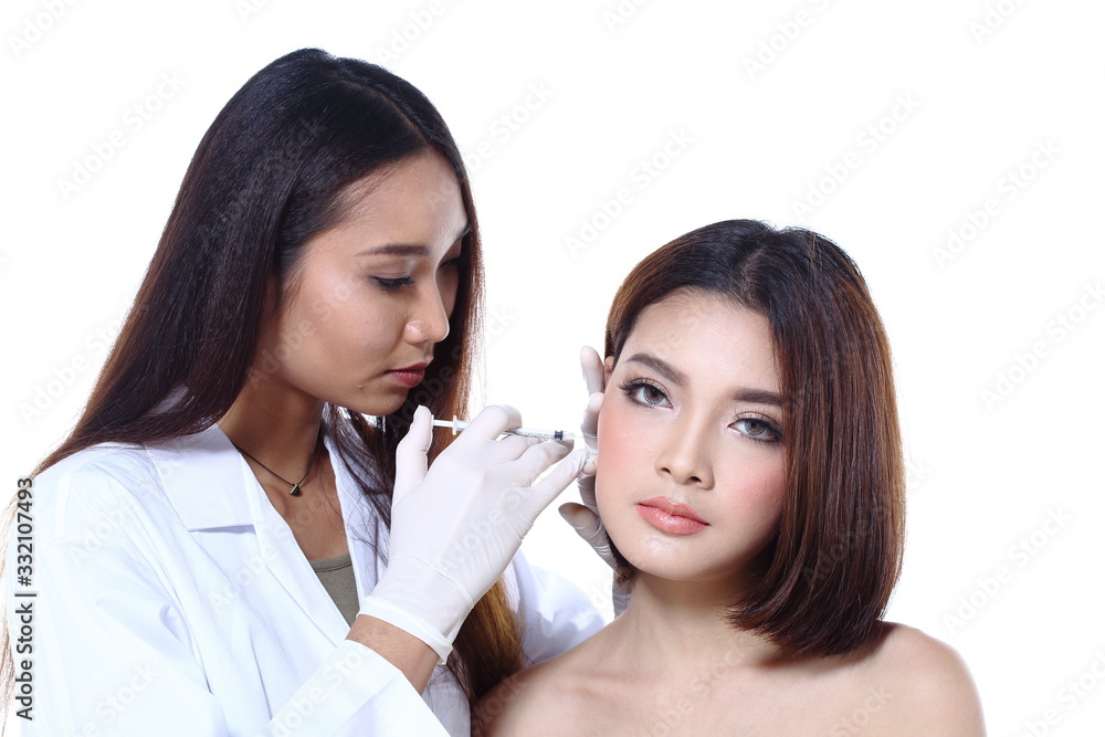 Nurse check woman's face who want to do eye, nose, eyebrow, forehead, cheek, jawline before plastic surgery, studio lighting white background copy space for text logo