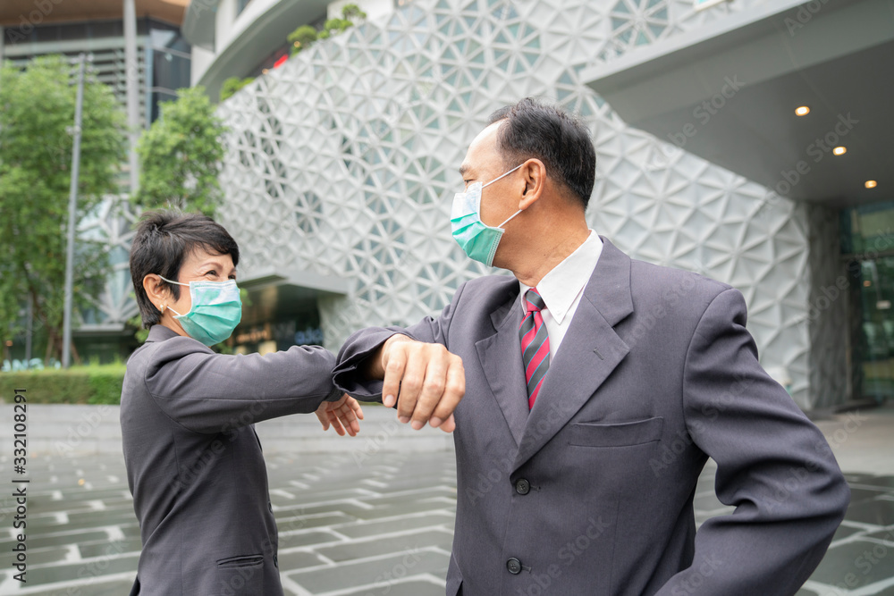 Old asian business people greeting togather by new methode with mask for prevent covid 19 Old asian business people greeting togather by new methode with mask for prevent covid 19