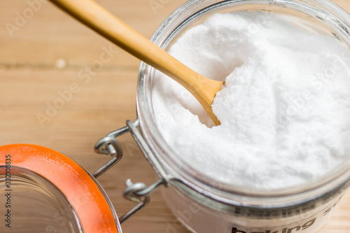 Closeup baking soda on wooden blackground photo