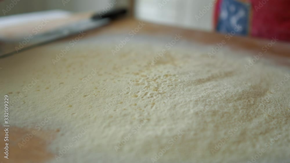 Close Up of pouring water drops on flour with straw broom, Italian Old Recipe Close Up of pouring water drops on flour with straw broom, Italian Old Recipe