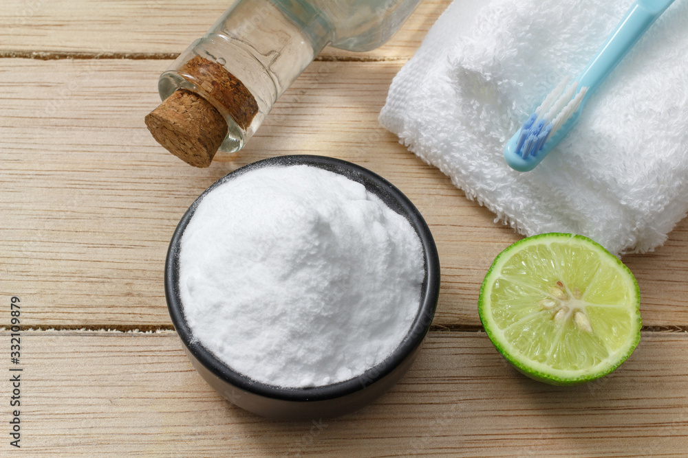 baking soda and lemon on wooden table baking soda and lemon on wooden table