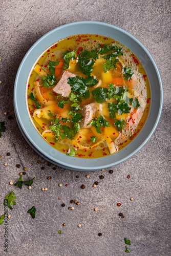 Delicious spicy soup with beef and noodle on grey background. Top view. Copy space for text.