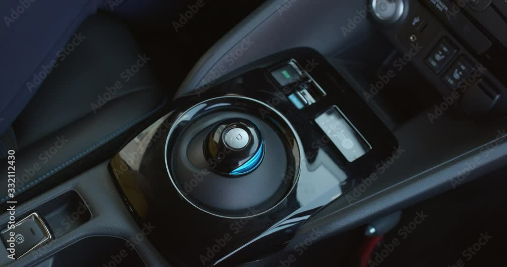 Pushes the parking brake button. Electric car parking shifter. Button