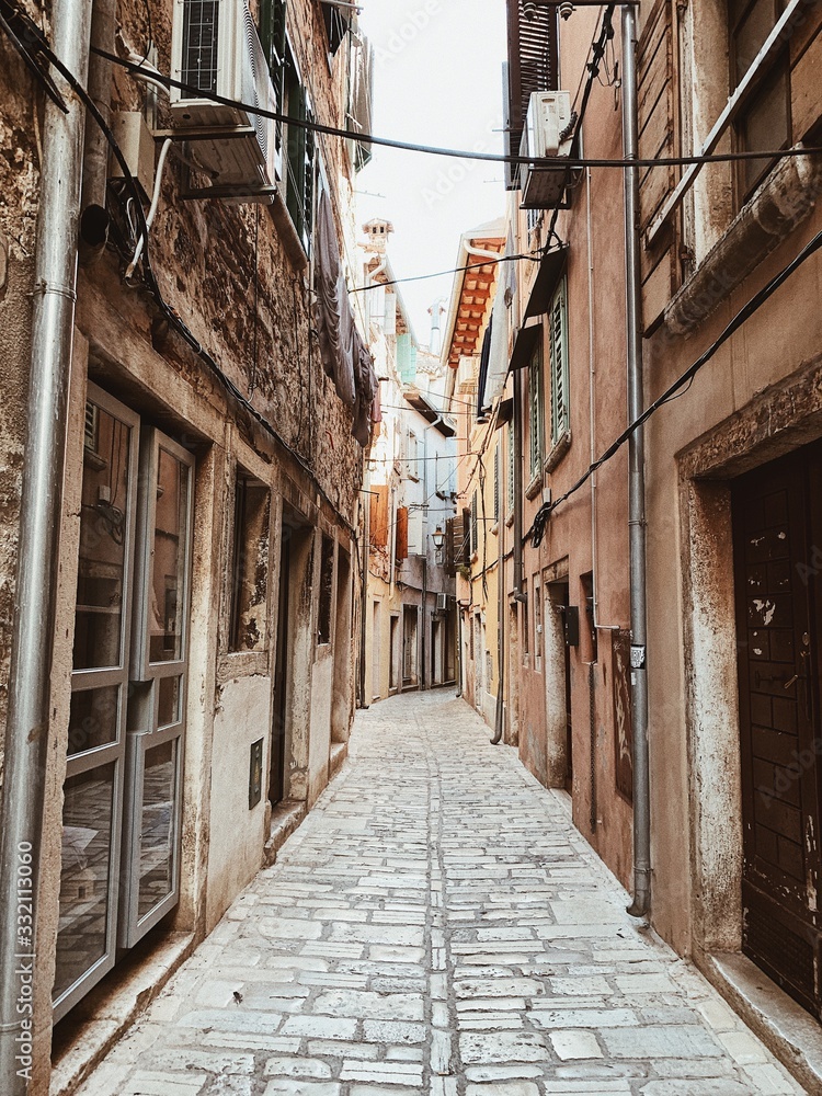 Fototapeta premium Narrow street of Rovinj, Istria region, Croatia, Europe 2019. Old town with vintage buildings. Empty street. Travel concept.
