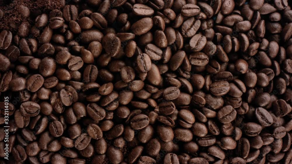 A 4k Close Up Shot Of Multiple coffee beans sitting on a table. Coffee bean shop. Coffee beans. Over the top view. A 4k Close Up Shot Of Multiple coffee beans sitting on a table. Coffee bean shop. Coffee beans. Over the top view.