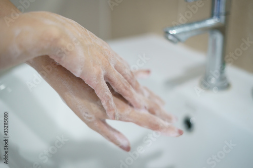 Washing hands with soap. For killing germs, bacteria and virus.