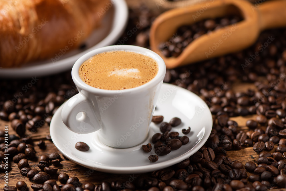 A cup of cappuccino with coffee bean as background. A cup of cappuccino with coffee bean as background.