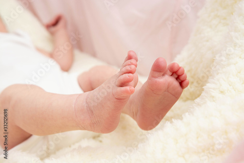 A close-up tiny baby feet. Childcare, safety and education concept.