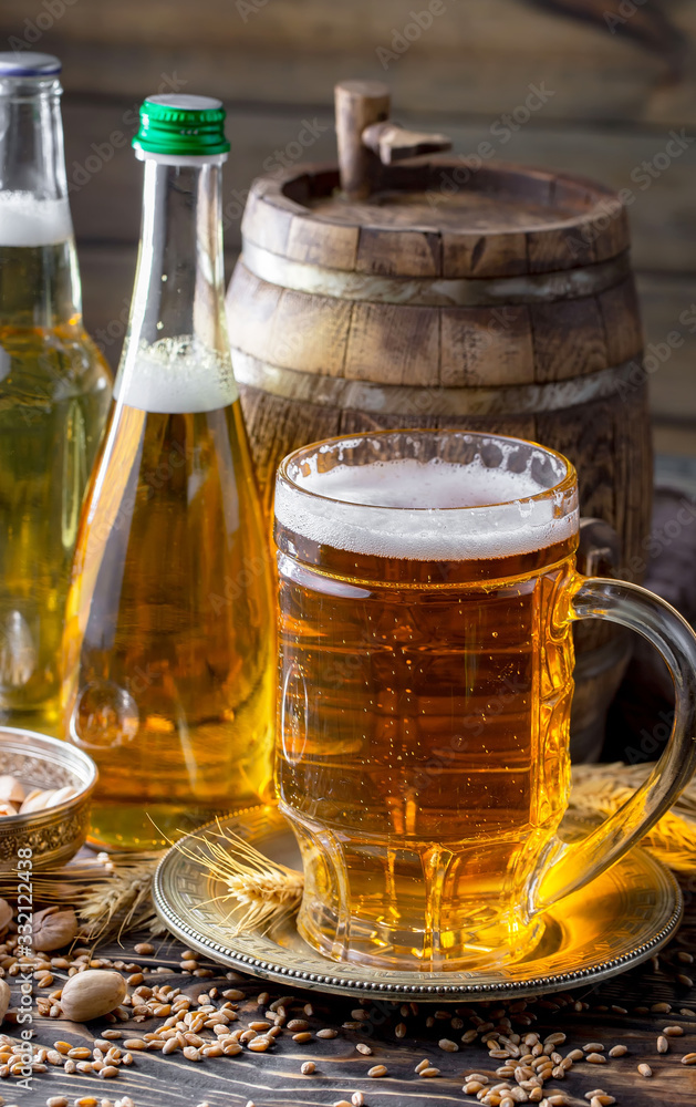 Light beer in a glass on a table in composition with accessories on an old background Light beer in a glass on a table in composition with accessories on an old background