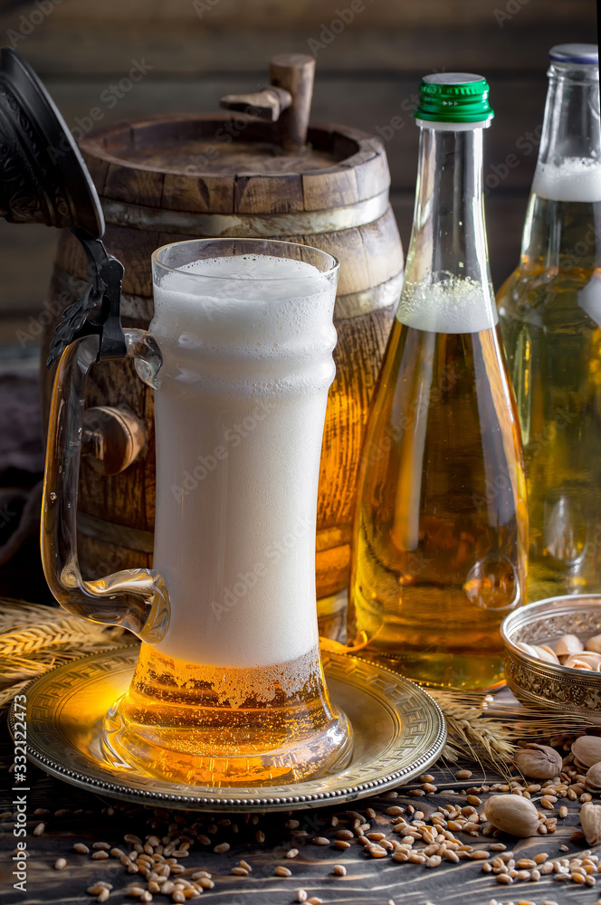 Light beer in a glass on a table in composition with accessories on an old background Light beer in a glass on a table in composition with accessories on an old background