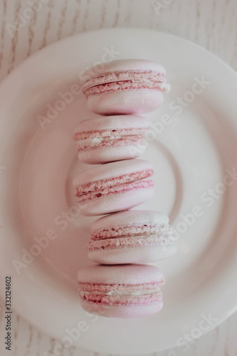 Strawberry french macarons closeup. Fresh and colourful on pink background