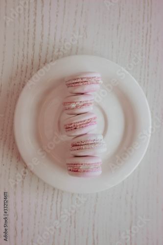Strawberry french macarons closeup. Fresh and colourful on pink background