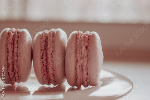 Strawberry french macarons closeup. Fresh and colourful on pink background