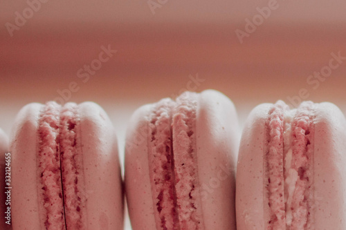 Strawberry french macarons closeup. Fresh and colourful on pink background