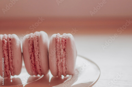 Strawberry french macarons closeup. Fresh and colourful on pink background