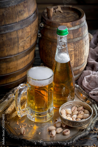 Light beer in a glass on a table in composition with accessories on an old background