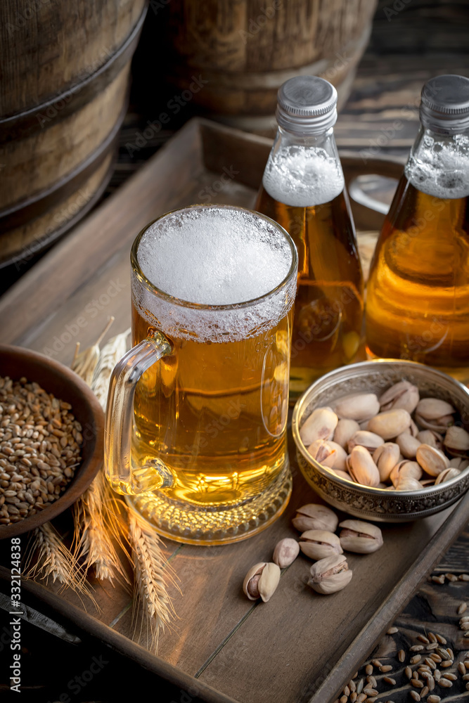 Light beer in a glass on a table in composition with accessories on an old background Light beer in a glass on a table in composition with accessories on an old background