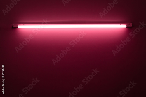 Pink neon lamp on a white wall