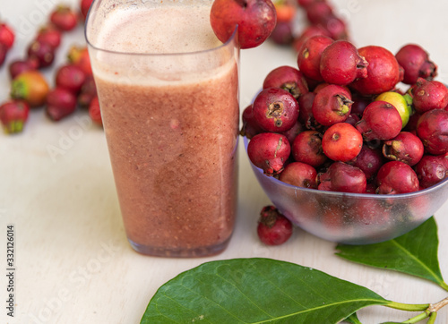 Glass of juice and fruits of red aracá (Psidium cattleyanum Sabine) in natura photo