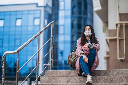 Female in medical protective mask outdoors in the empty city. Health protection and prevention of virus outbreak, coronavirus, COVID-19, epidemic and pandemic, quarantine concept