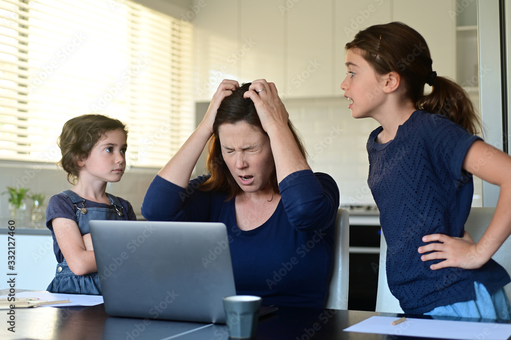 Upset mother forced to work from home as the pandemic coronavirus (COVID-19) forces many employees to work from home. Upset mother forced to work from home as the pandemic coronavirus (COVID-19) forces many employees to work from home.