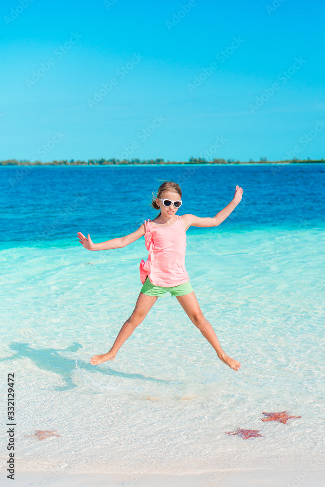 Beautiful little girl at beach having fun. Funny girl enjoy summer vacation. Beautiful little girl at beach having fun. Funny girl enjoy summer vacation.