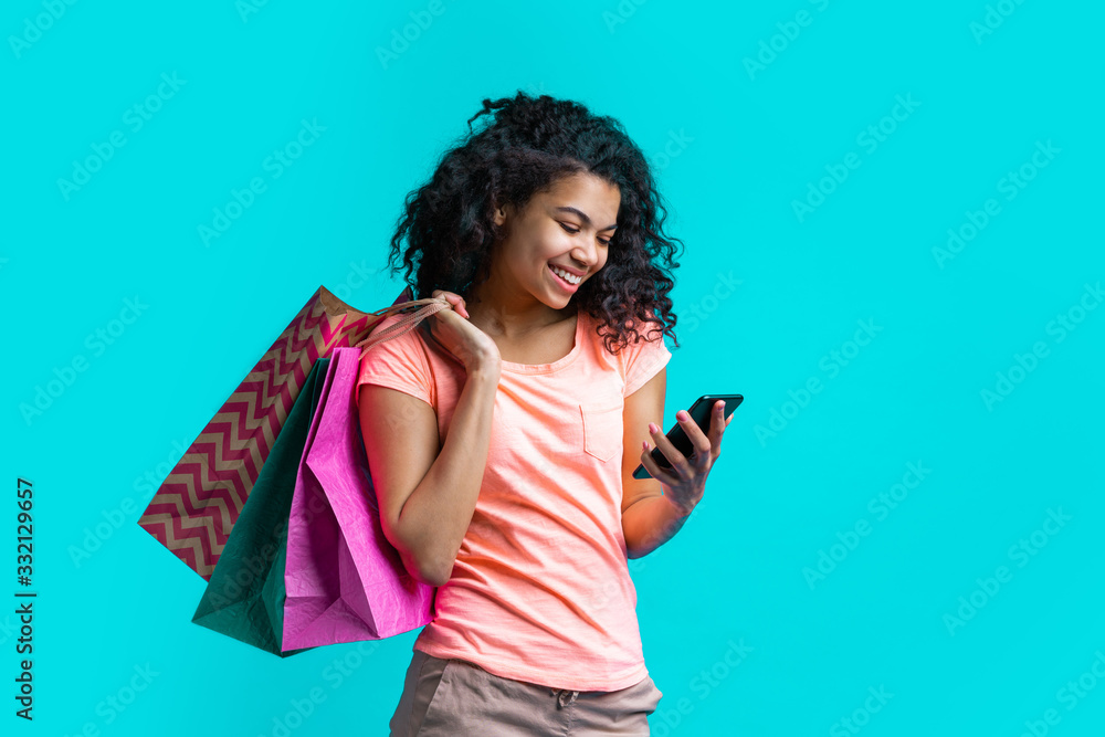Attractive young dark skinned woman with a bunch of shopping bags Attractive young dark skinned woman with a bunch of shopping bags