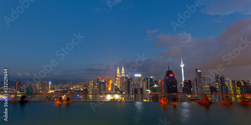 Canvas Print City skyline at famous rooftop swiming pool at evening , with night city Kuala L