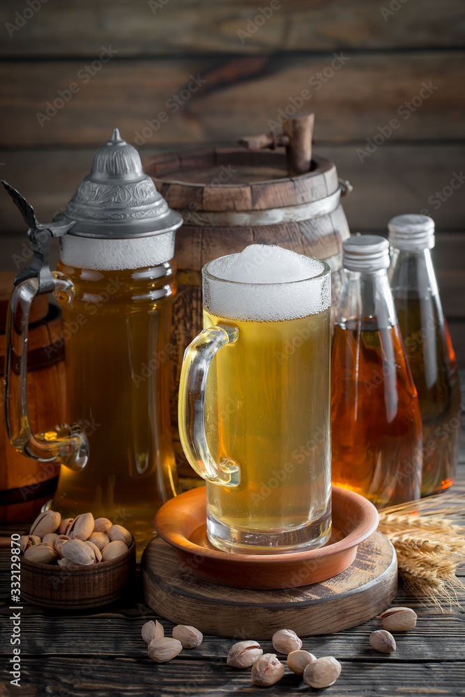 Light beer in a glass, on an old background. Light beer in a glass, on an old background.