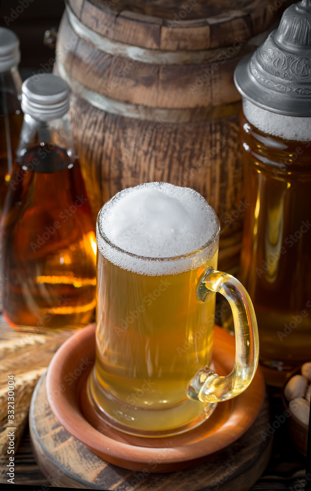 Light beer in a glass on a table in composition with accessories on an old background Light beer in a glass on a table in composition with accessories on an old background