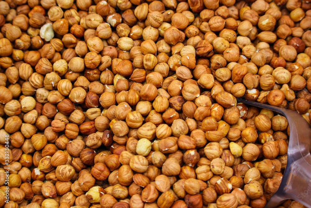 peeled hazelnuts in a tray with a spatula in a supermarket peeled hazelnuts in a tray with a spatula in a supermarket