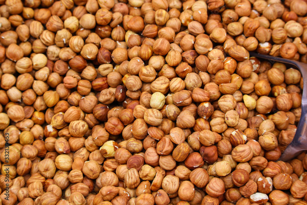 peeled hazelnuts in a tray with a spatula in a supermarket peeled hazelnuts in a tray with a spatula in a supermarket